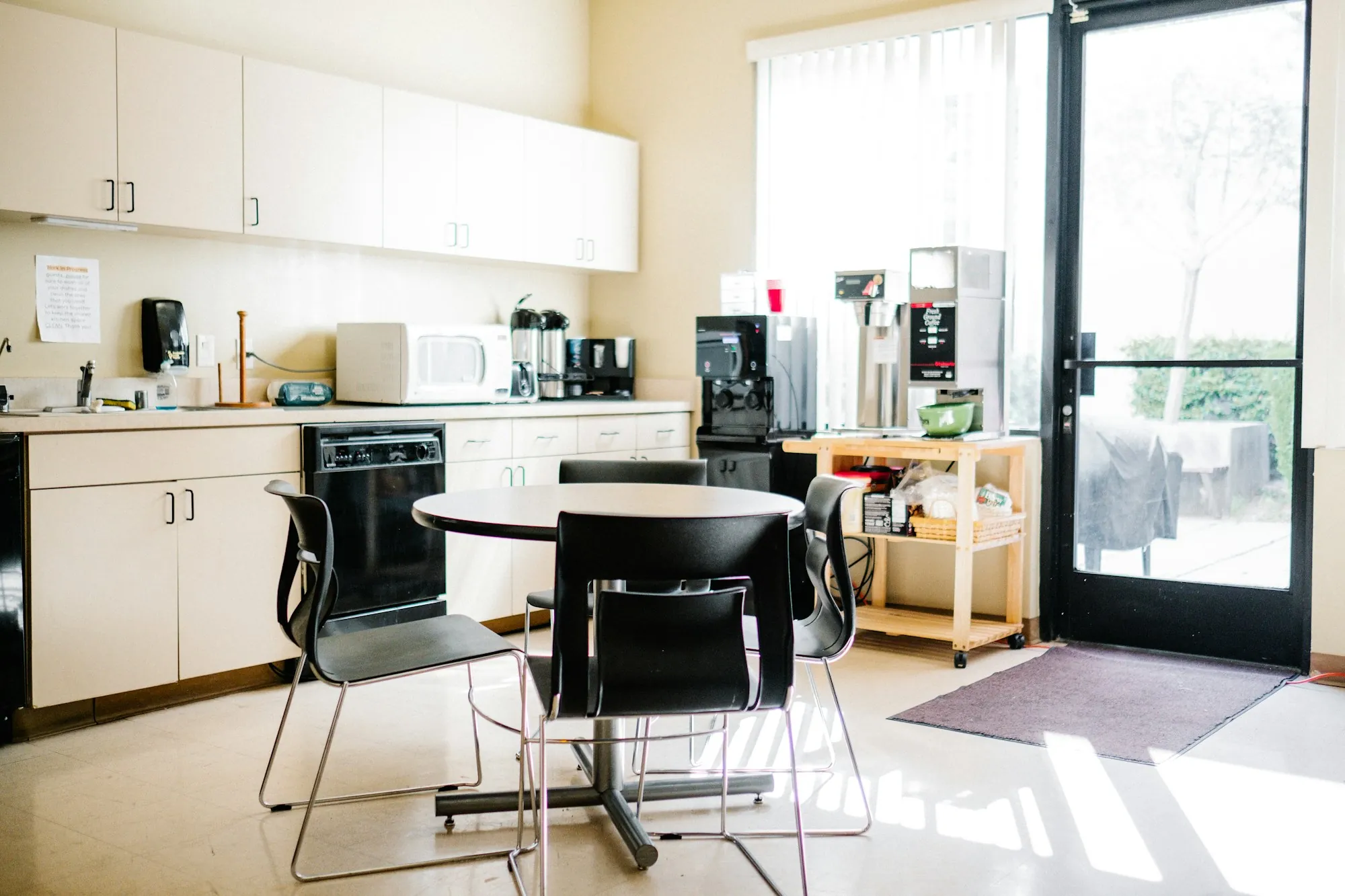 Breakroom with tables, appliances and natural light