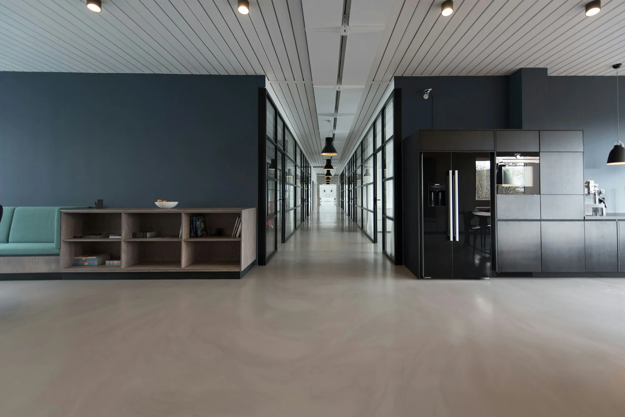 Office hallway with a shiny floor and a breakroom